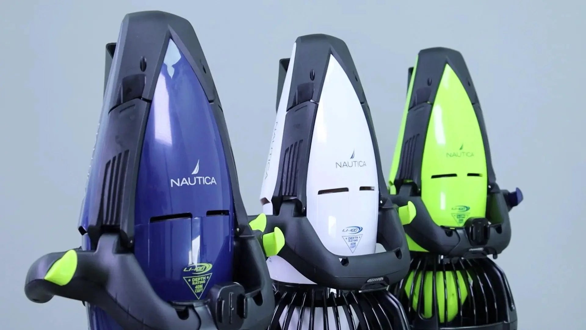 Three Nautica Seascooters in blue, white, and green, designed for underwater adventures.